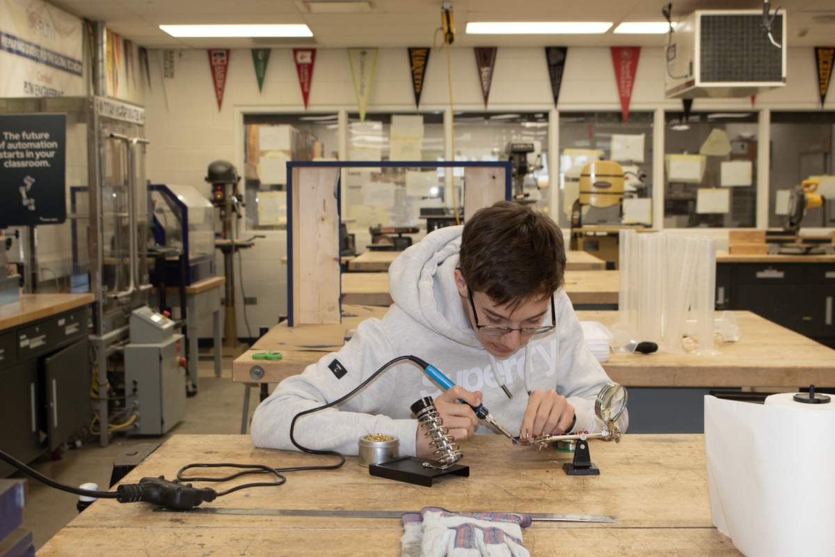 Senior Dominik Grzeszczak sodders on a printed circuit board that he designed himself in South’s Makerspace, completing a prototype of his MakerFaire project. The SELC and Engineering classes Grzeszczak has taken offer access to the Makerspace, filled with tools that allow South students to create anything that comes to their imagination. 
